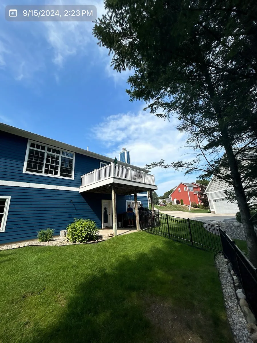 Before photo of a wooden deck slated for a conversion by general contractors in Traverse City