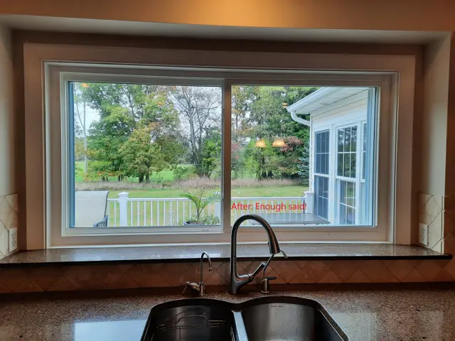 After view of a Mason MI kitchen featuring a new, large energy-efficient slider window with no grids providing a clear view of the backyard.