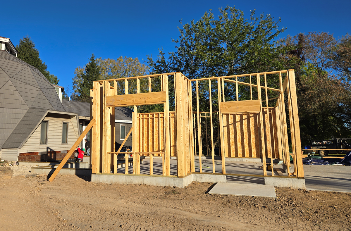 Side view of the wood wall framing for a new garage and laundry room addition under construction at a home in Ada Township, Michigan.