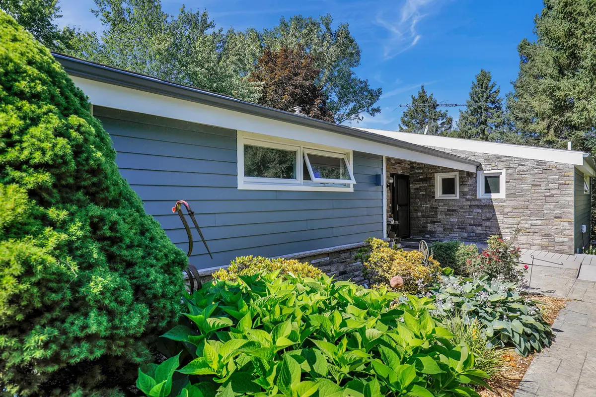 After James Hardie siding installers Michigan completed dark blue fiber cement and stone renovation