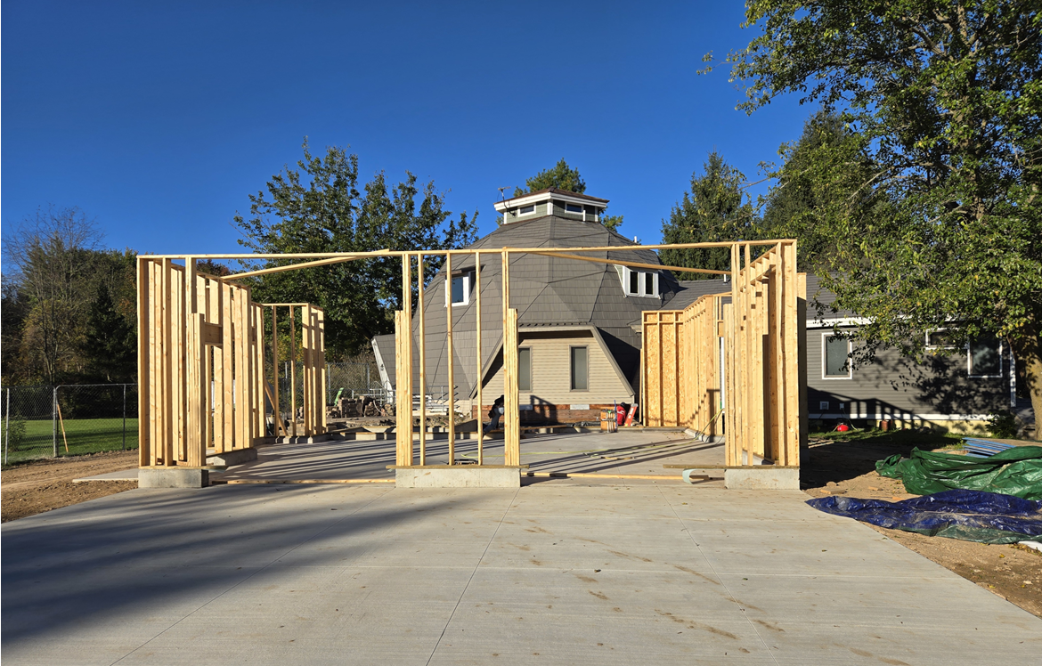 Wood framing for a new garage and laundry room addition being built onto a geodesic dome home in Lansing, Michigan.