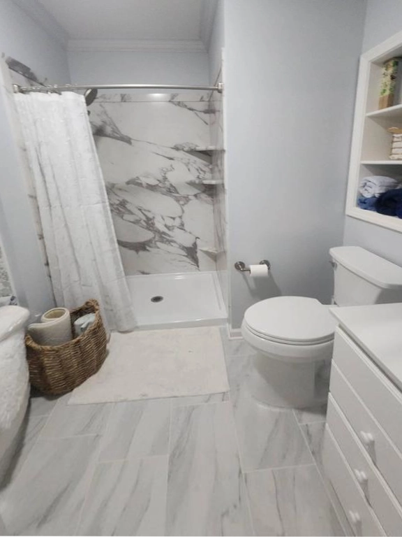 New walk-in shower with marble-look waterproof walls and flooring in Grand Rapids remodel.