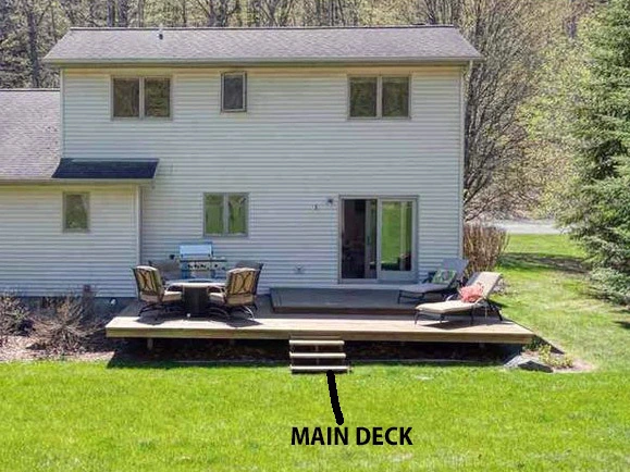 Old wood deck requiring replacement by expert home improvement contractors in Traverse City.