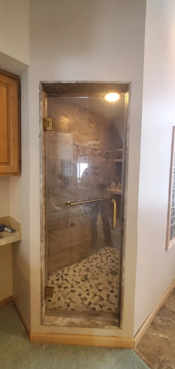 Finished glass shower door installation by Traverse City contractors