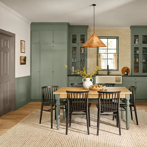 Warm Eucalyptus green cabinetry and wainscoting with vinyl plank flooring, inspiring bathroom design ideas.