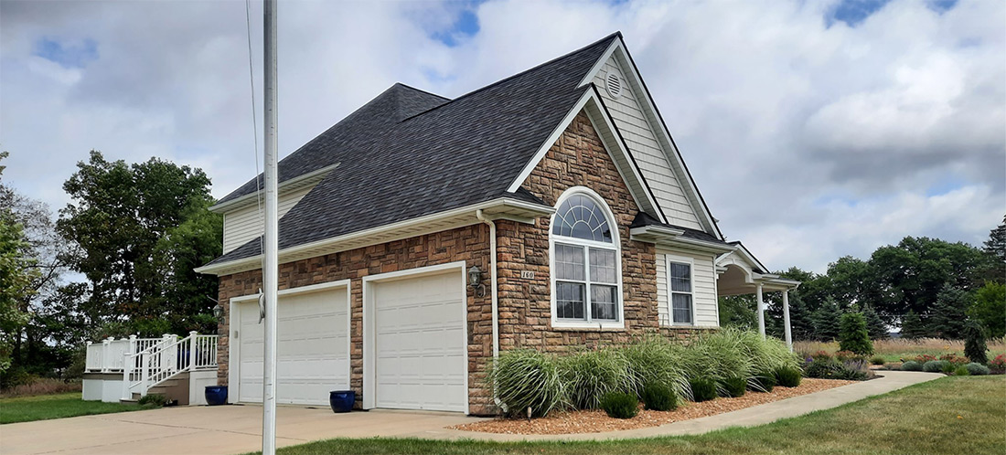 Durable Malarkey Roofing with Beautiful Boral Versetta Stone Accent Wall in Mason, Michigan