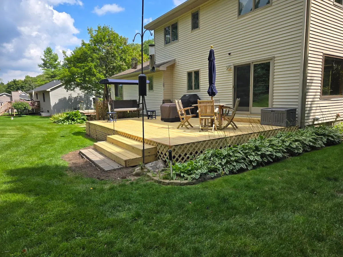 Finished wood deck with lattice skirting completed by a Traverse City home improvement company.