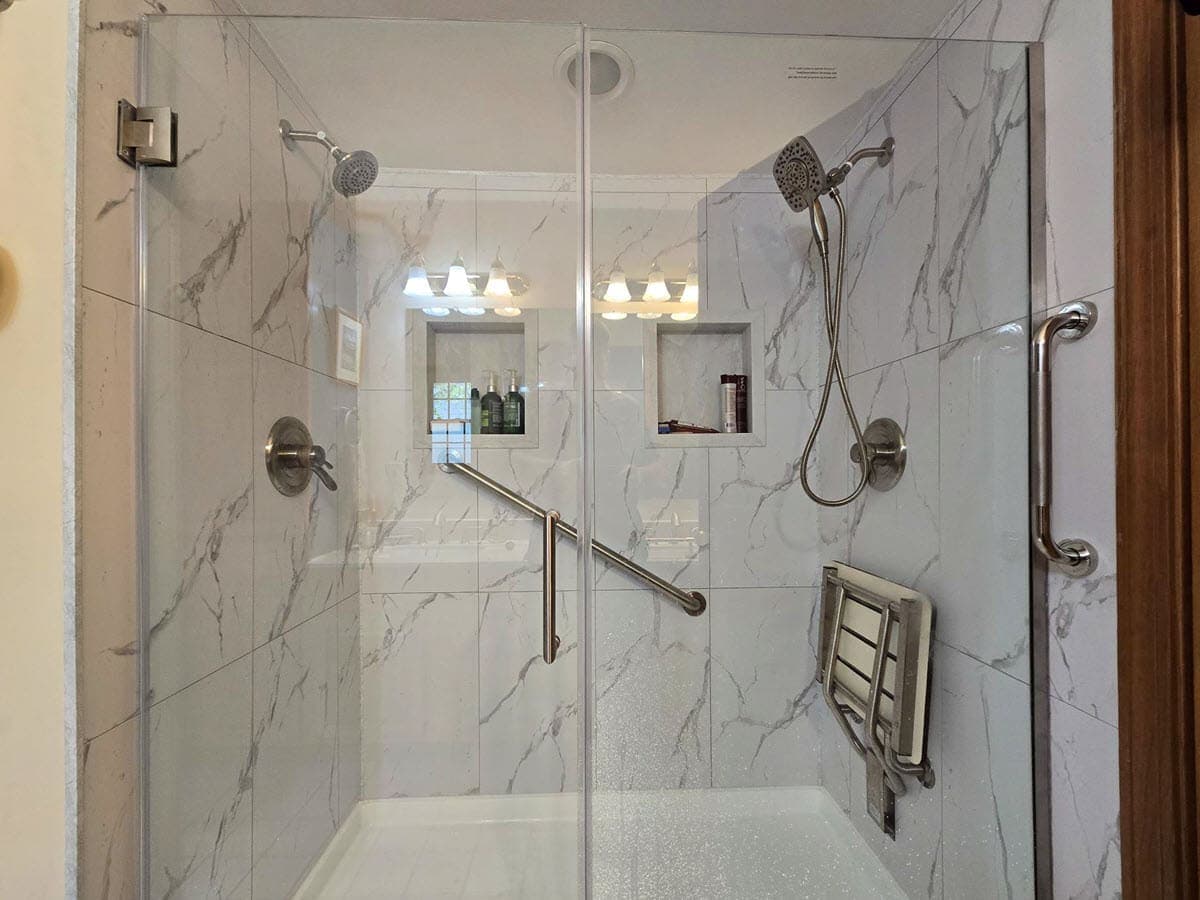 After photo of a luxury walk-in shower installation with bathroom floor tiles
