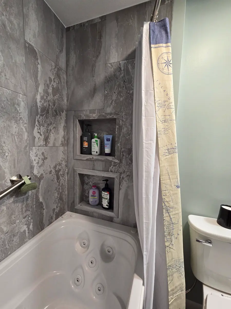Custom shower niche shelving in Palisade wall system installed by local contractors.