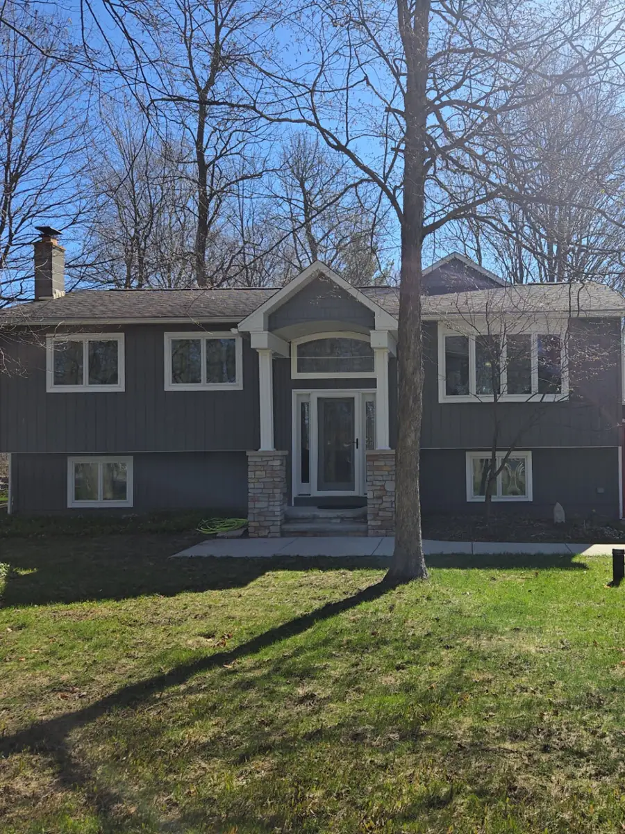 Front of house before new siding installation by home remodeling contractors