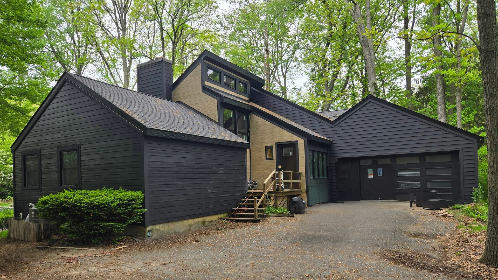 A beautiful home in Holland, MI, with new black James Hardie fiber cement siding, highlighting its curb appeal and durable protection.
