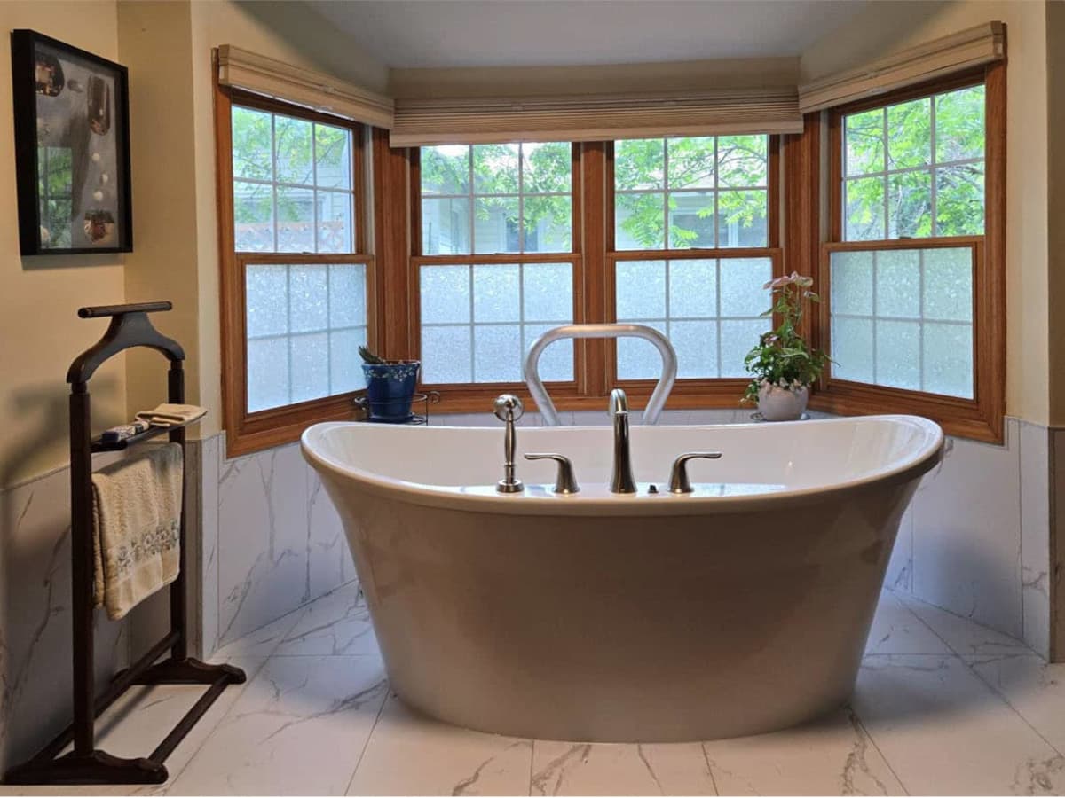 After photo of a freestanding tub and heated bathroom floors