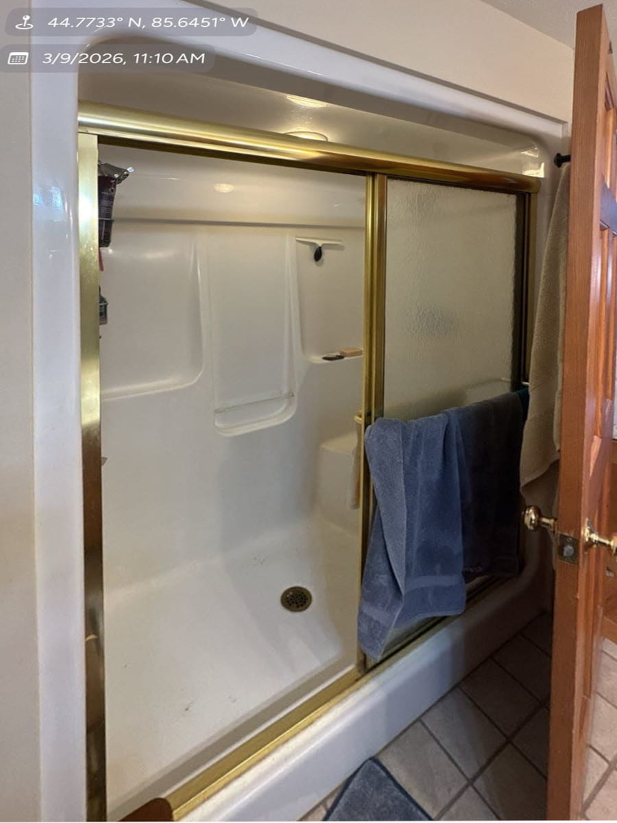 Before photo of an old fiberglass shower insert requiring home improvement contractors