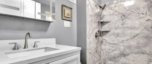 Completed Ada, MI custom bathroom remodel featuring a Palisade tile walk-in shower, granite vanity top, and modern LED medicine cabinet.